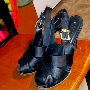 Black heels with toe hole.